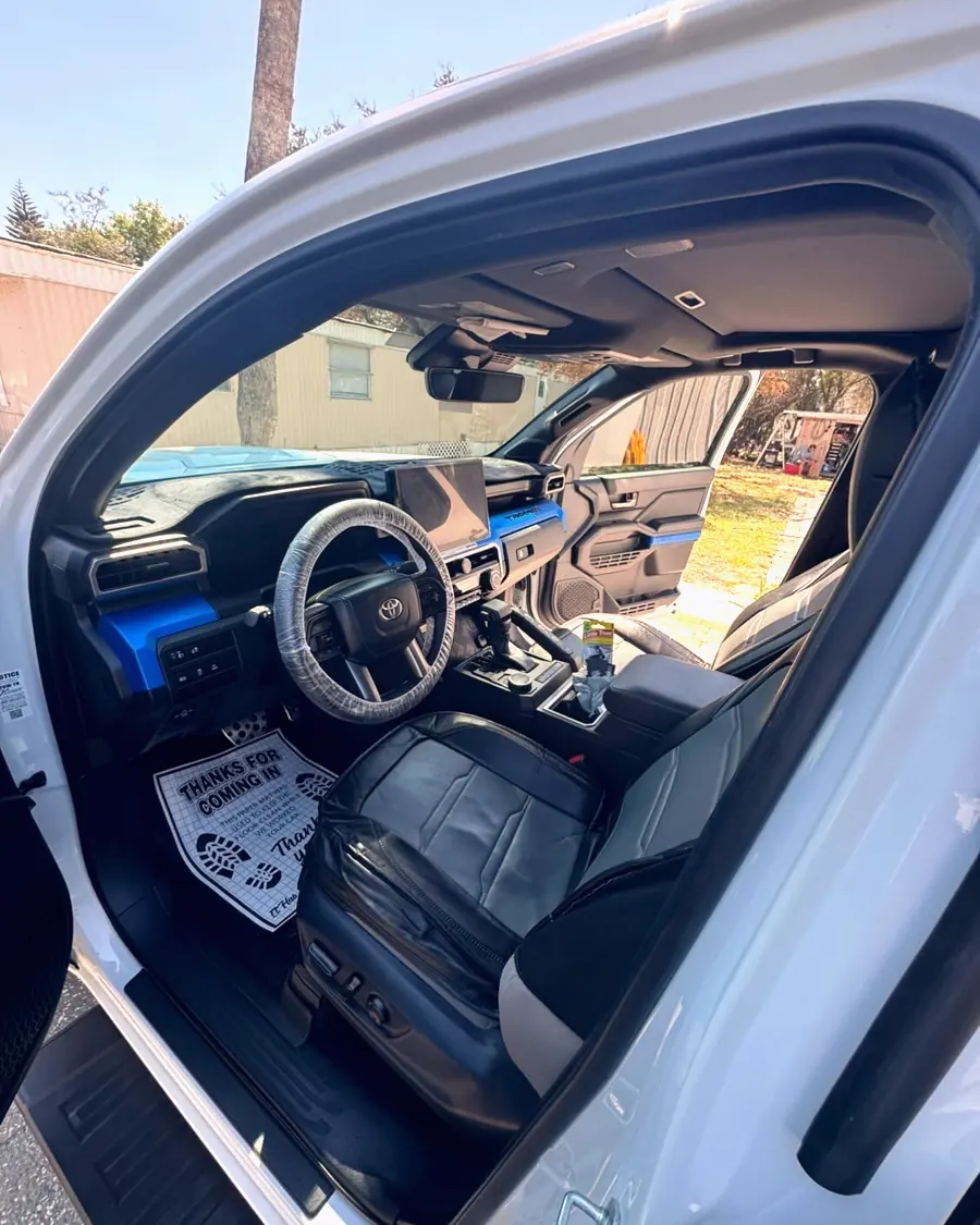 A white pickup interior with blue ambient lighting after a deep clean