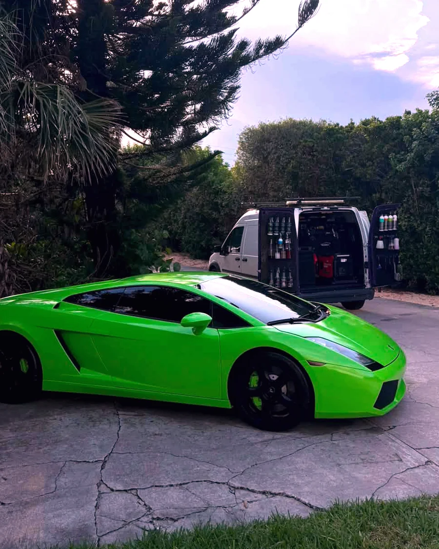 A green Lamborghini Gallardo detailed at a client home, GaliGloss van behind it