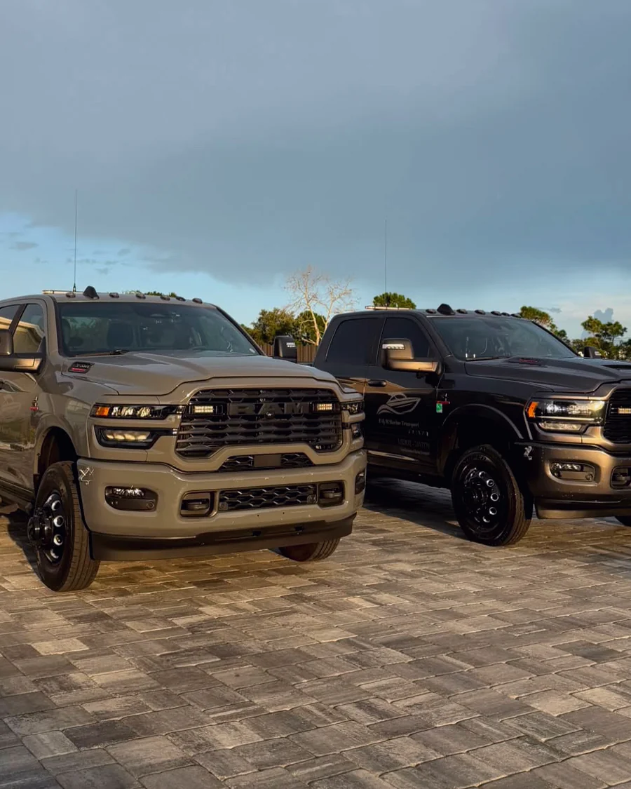 A pair of RAM heavy duty dually trucks on a paver driveway