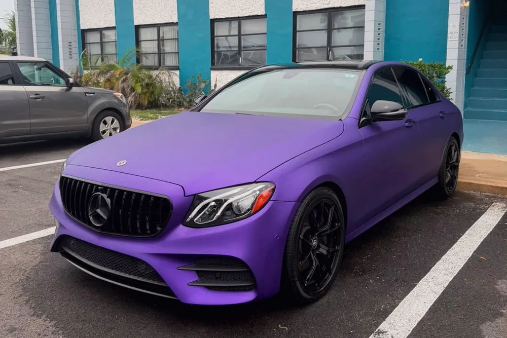 A Mercedes E-Class in a matte purple wrap after a GaliGloss exterior detail